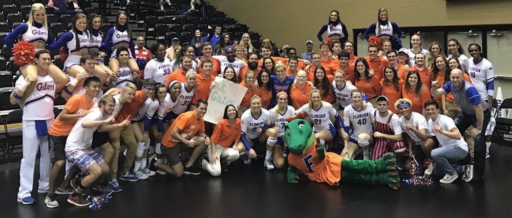 <p>The UF volleyball team celebrates its sweep of FGCU (25-17, 25-13, 25-17) in the second round of the NCAA Tournament with some fans and the Florida band.&nbsp;</p>