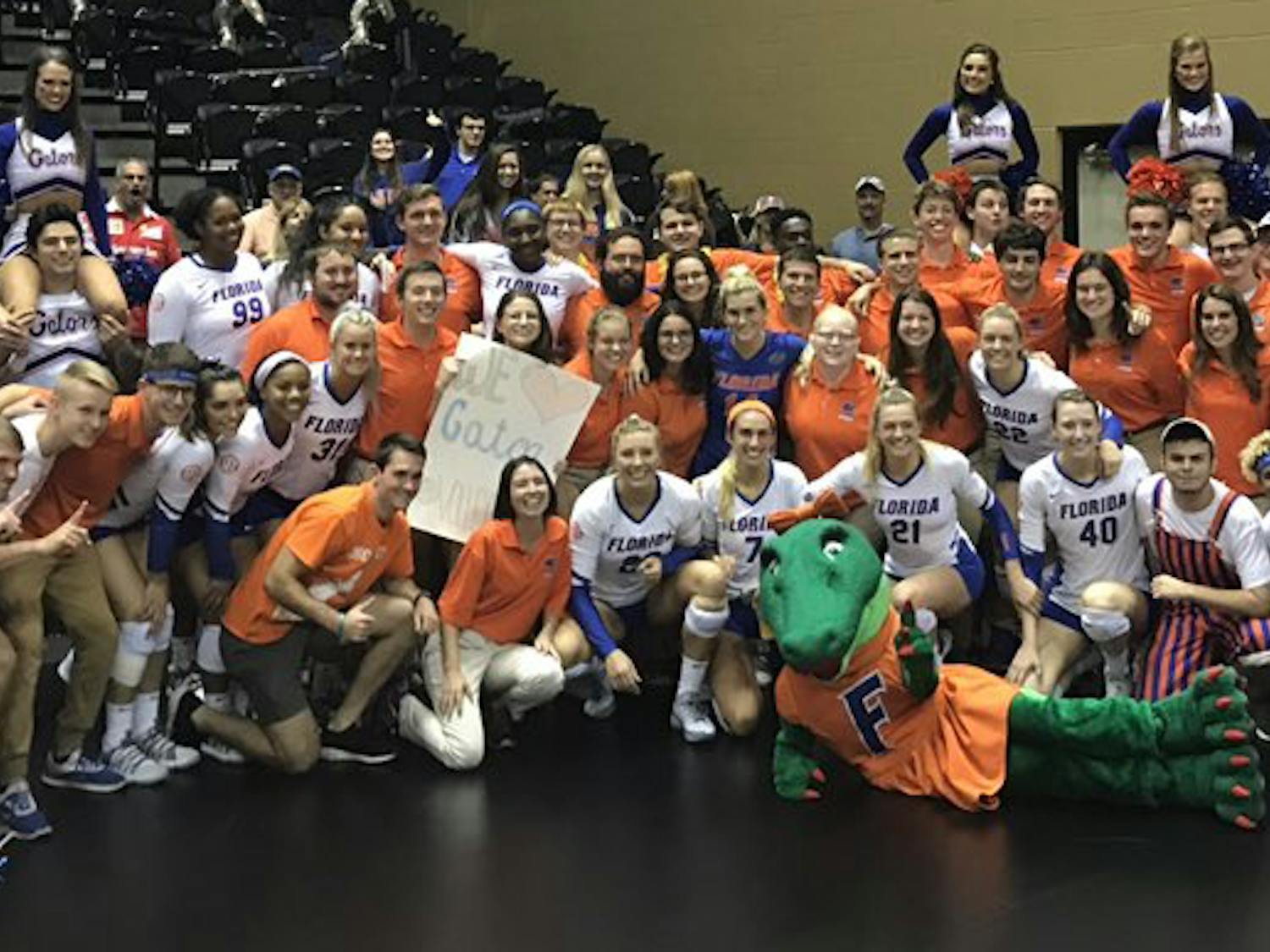 The UF volleyball team celebrates its sweep of FGCU (25-17, 25-13, 25-17) in the second round of the NCAA Tournament with some fans and the Florida band. 