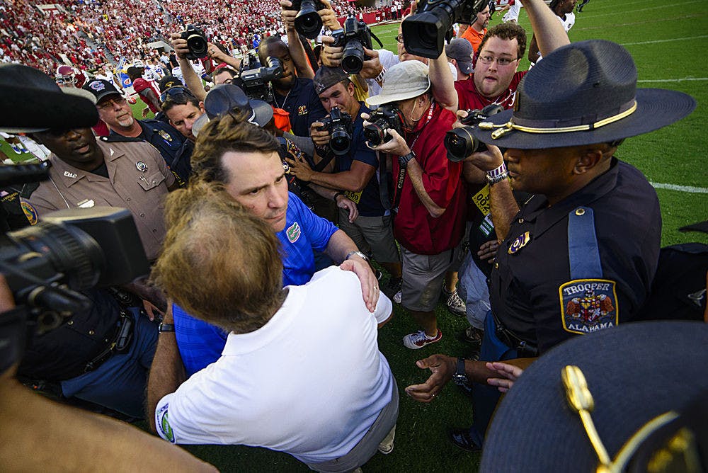 Florida coach Will Muschamp and Alabama coach Nick Saban embrace following Florida's 42-21 loss to Alabama on Saturday at Bryan-Denny Stadium in Tuscaloosa, Ala.