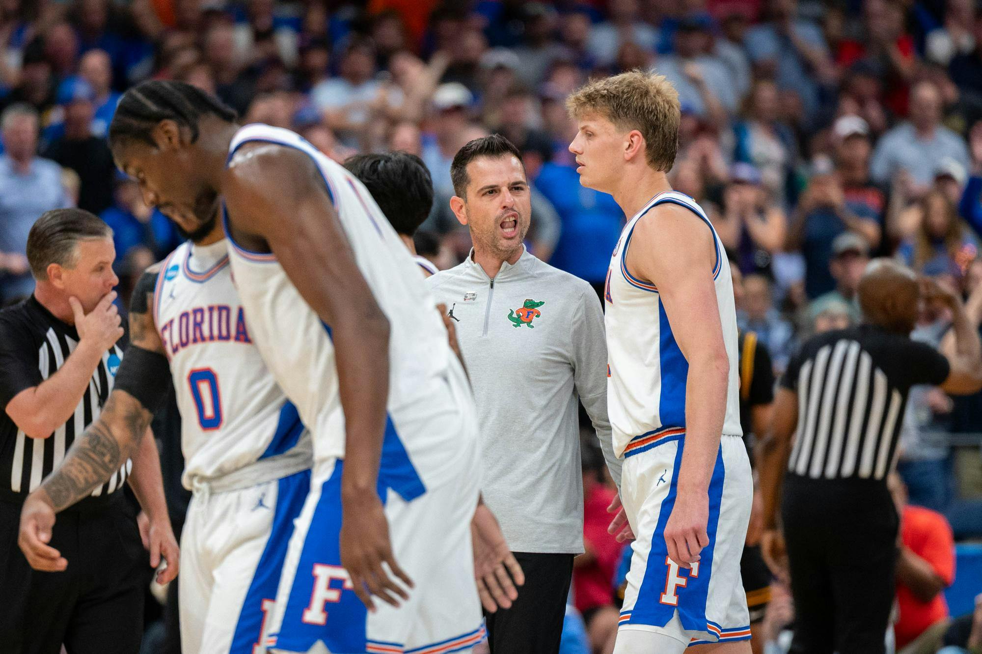 Florida head coach Todd Golden speaks with his team during the first half of an NCAA Tournament second round game against Iowa, Sunday, March 22, 2026, in Tampa, Fla.