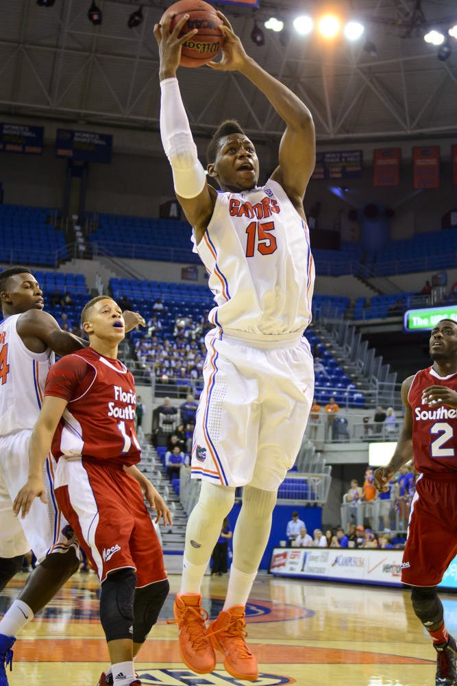 Senior forward Will Yeguete grabs a rebound during No. 10 Florida's 110-88 win against Florida Southern on Friday night in the O'Connell Center. Yeguete scored 12 points and added nine rebounds in the victory.