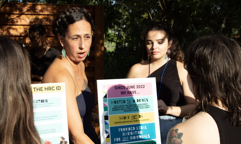 Veronica Robleto, ID program director for the Human Rights Coalition of Alachua County, explains the function of community ID cards at a fundraiser at Superette on Friday, Sept. 15, 2023.