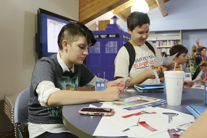 Neylan Barthelme, 18, and Emma Nolan, 18, put together a miniature TARDIS and Dalek mask at the Doctor Who event at the Alachua County Library on Friday.