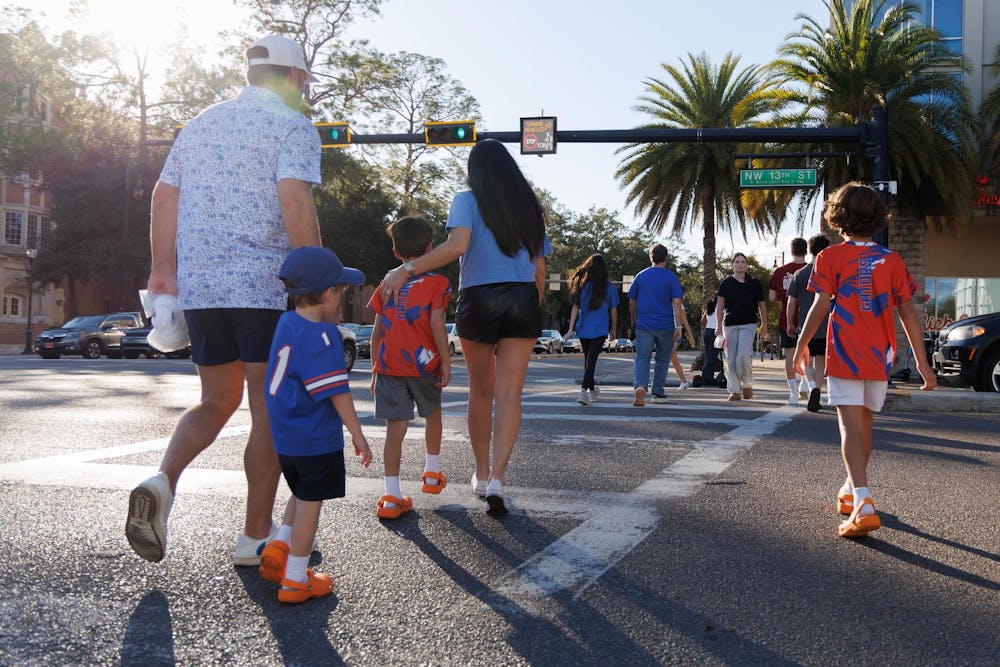 Pedestrians crossing at University Avenue and NW 13th Street, Saturday, Jan. 10, 2025.