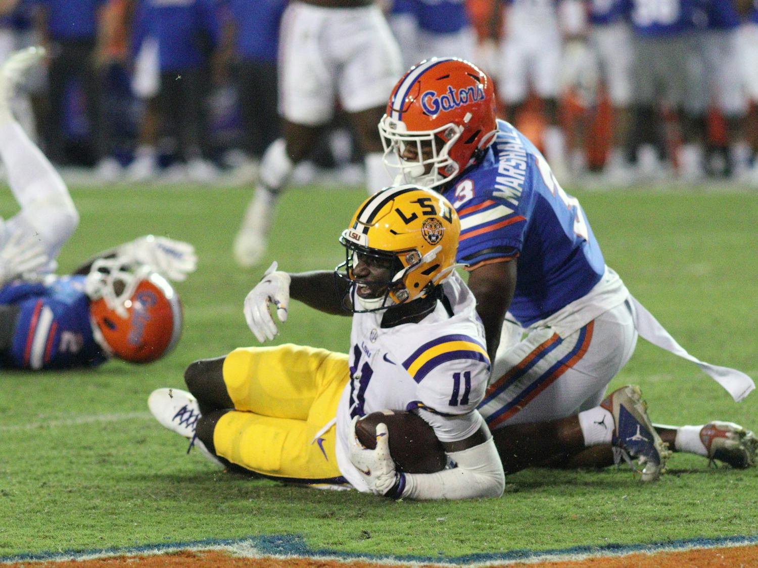 LSU wide receiver Brian Thomas Jr. after a reception with UF cornerback Jason Marshall Jr. in coverage Saturday, Oct. 15, 2022.