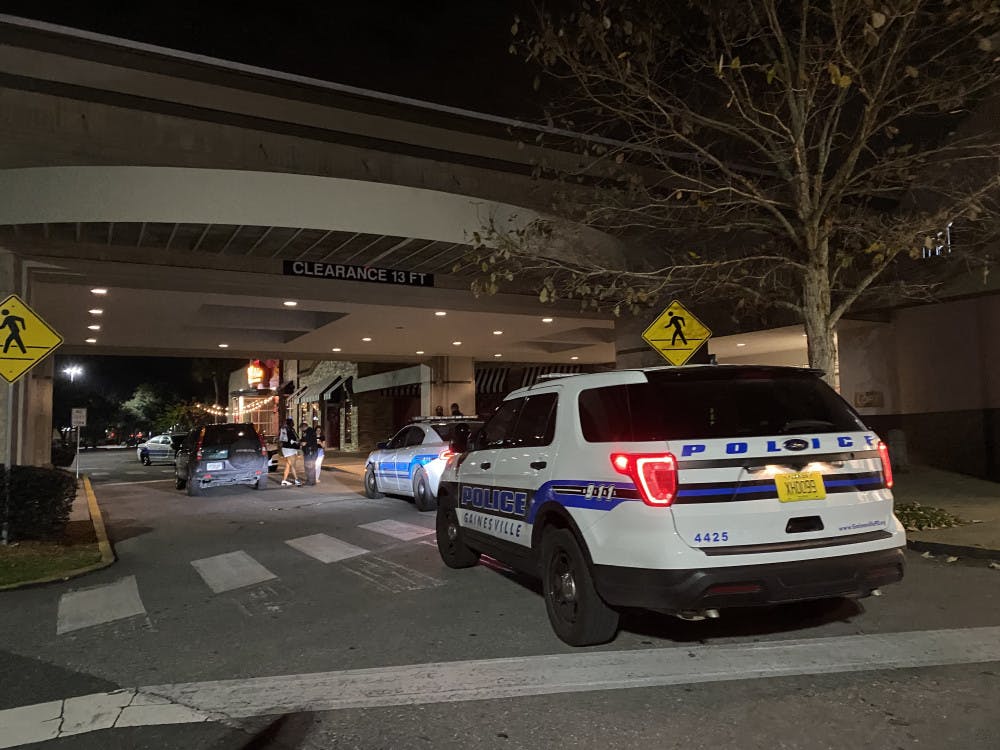 <p><span>Law enforcement officers interview witnesses in front of Oaks Mall Thursday night after reports of a robbery in front of Pearle Vision, an eye care store located inside the mall. </span></p>