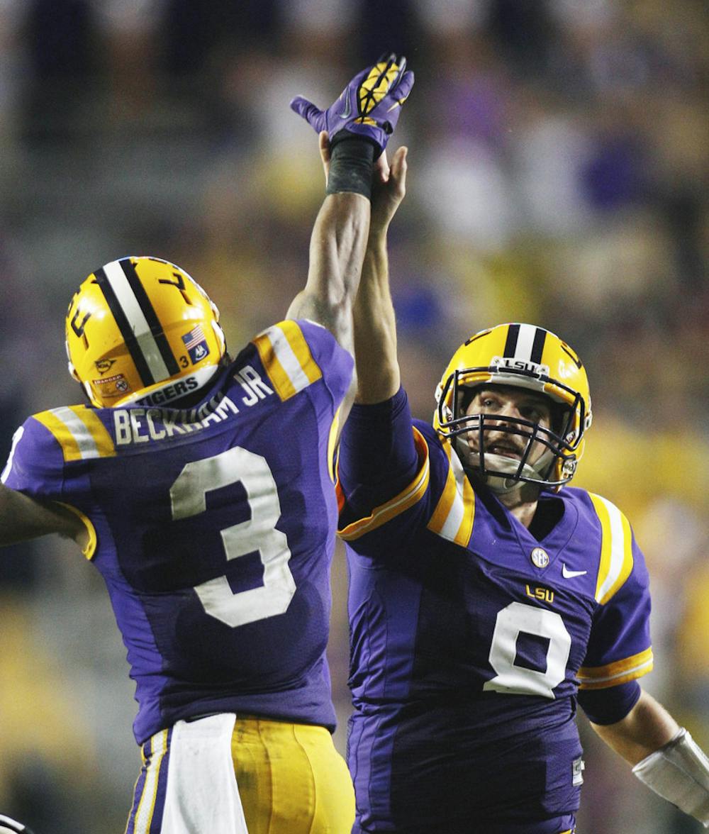 <p>LSU junior quarterback Zach Mettenberger (8) and sophomore wide receiver Odell Beckham (3) congratulate each other after Mettenberger threw Beckham a 53-yard touchdown pass in the second half against Towson on Saturday. The No. 4 Tigers visit the No. 10 Florida Gators this weekend in Ben Hill Griffin Stadium. LSU fumbled five times last week.</p>