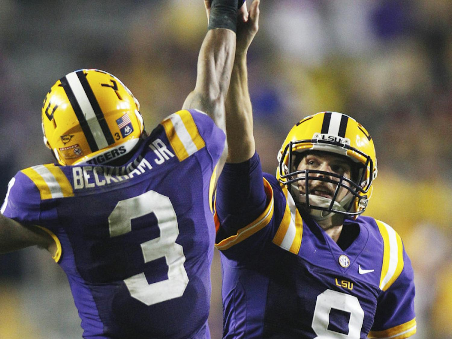 LSU junior quarterback Zach Mettenberger (8) and sophomore wide receiver Odell Beckham (3) congratulate each other after Mettenberger threw Beckham a 53-yard touchdown pass in the second half against Towson on Saturday. The No. 4 Tigers visit the No. 10 Florida Gators this weekend in Ben Hill Griffin Stadium. LSU fumbled five times last week.