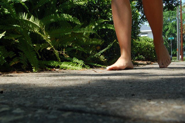Kayla Malone, a 19-year-old freshman, walks around without shoes Tuesday. The political science major is partaking in the One Day Without Shoes campaign by TOMS Shoes to spread awareness on the impact a pair of shoes can have on children in poverty.