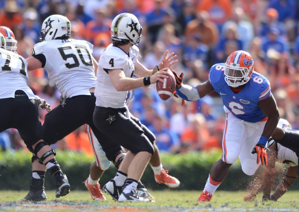 <p>Dante Fowler Jr. (6) rushes Vanderbilt quarterback Patton Robinette during the Gators 34-17 loss to the Commodores on Nov. 9 at Ben Hill Griffin Stadium.</p>