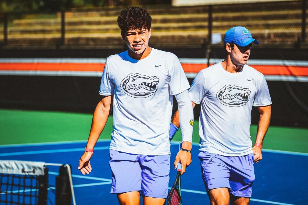 Freshman Ben Shelton walks alongside doubles teammate Will Grant after dropping a match, 8-7, against Auburn on Oct. 2 at the Tiger Fall Invitational in Auburn, Alabama.