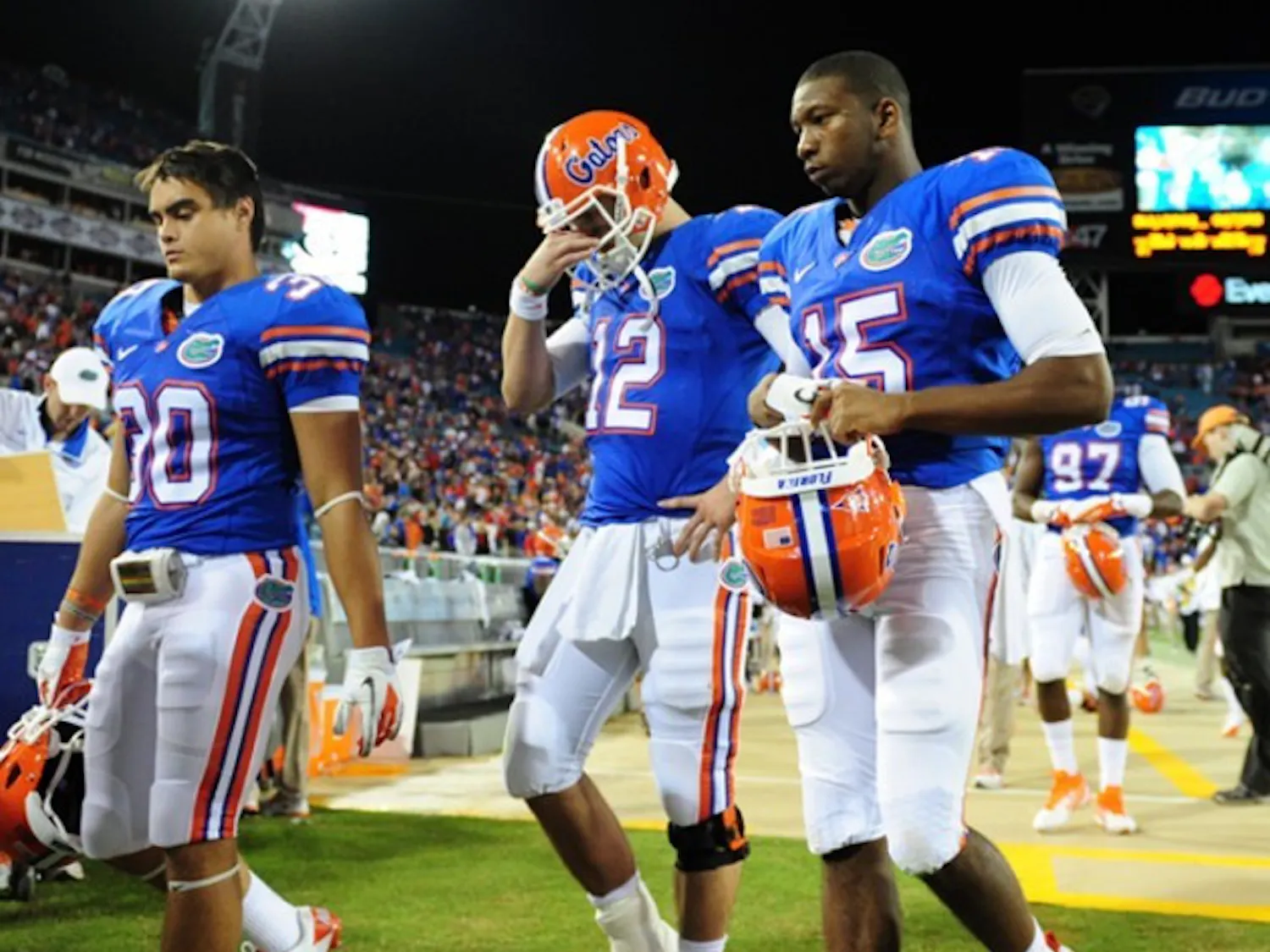 Florida quarterback John Brantley (12), safety Tim Clark (30) and cornerback Louchiez Purifoy (15) walk off the field in Jacksonville after losing 24-20 to Georgia. It was UF’s fourth straight loss in October.