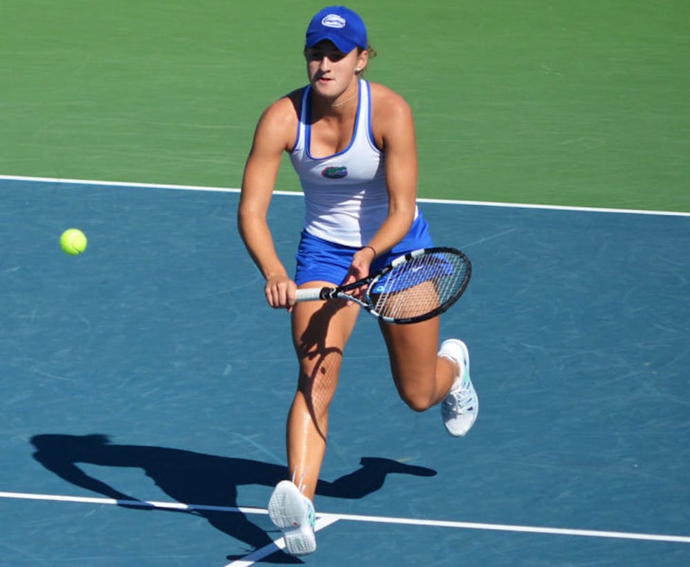<p>Kourtney Keegan attempts a volley during the Bedford Cup on Oct. 13, 2013, at the Ring Tennis Complex. Keegan won both of her singles matches in Florida’s opening weekend.</p>