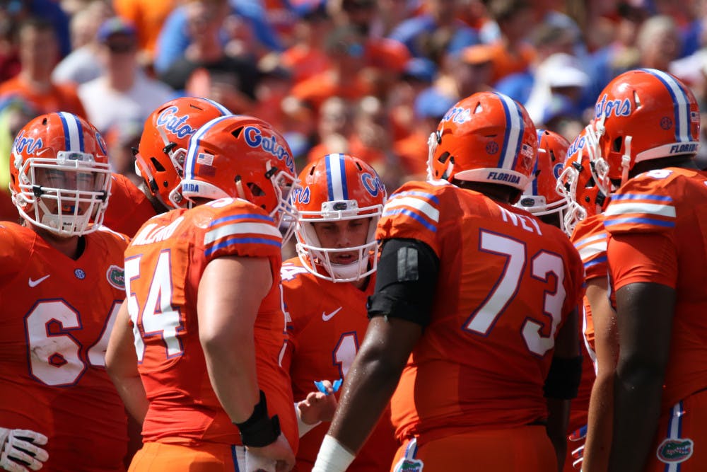 Luke Del Rio (center) huddles with Florida's offensive line during UF's 45-7 over Kentucky on Sept. 10, 2016, at Ben Hill Griffin Stadium.