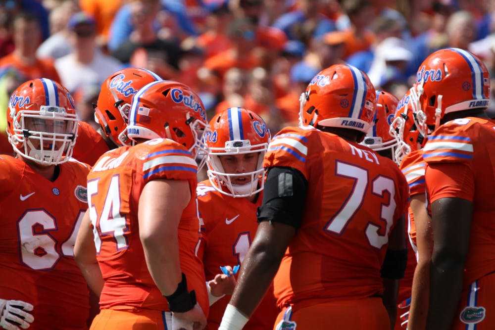 <p>Luke Del Rio (center) huddles with Florida's offensive line during UF's 45-7 over Kentucky on Sept. 10, 2016, at Ben Hill Griffin Stadium.</p>