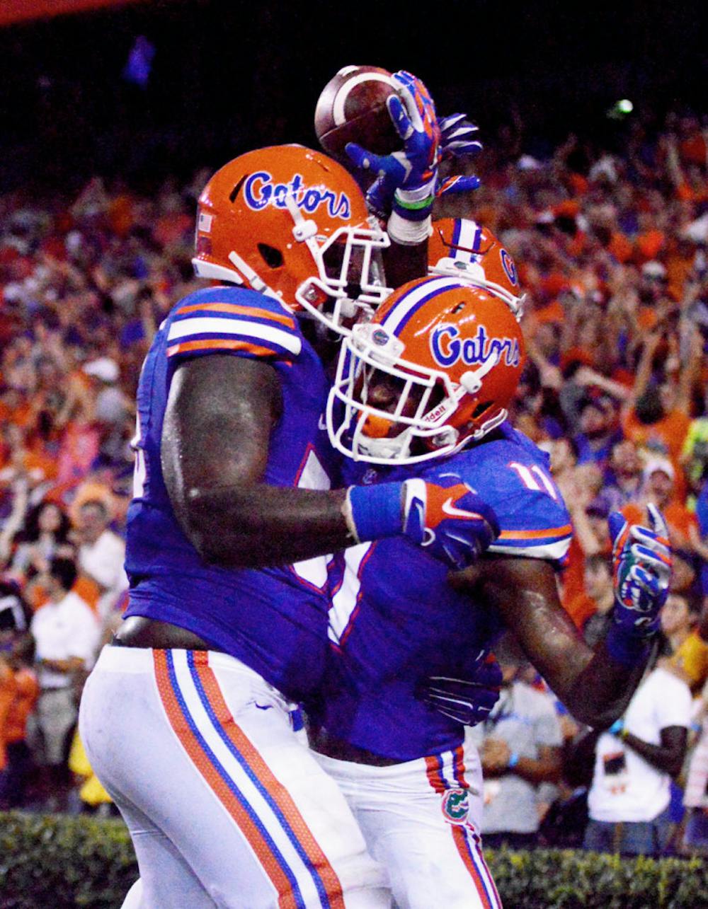 <p>Teammates celebrate a touchdown with sophomore wide receiver Demarcus Robinson (11) during Florida's 36-30 overtime victory against Kentucky on Saturday at Ben Hill Griffin Stadium.</p>