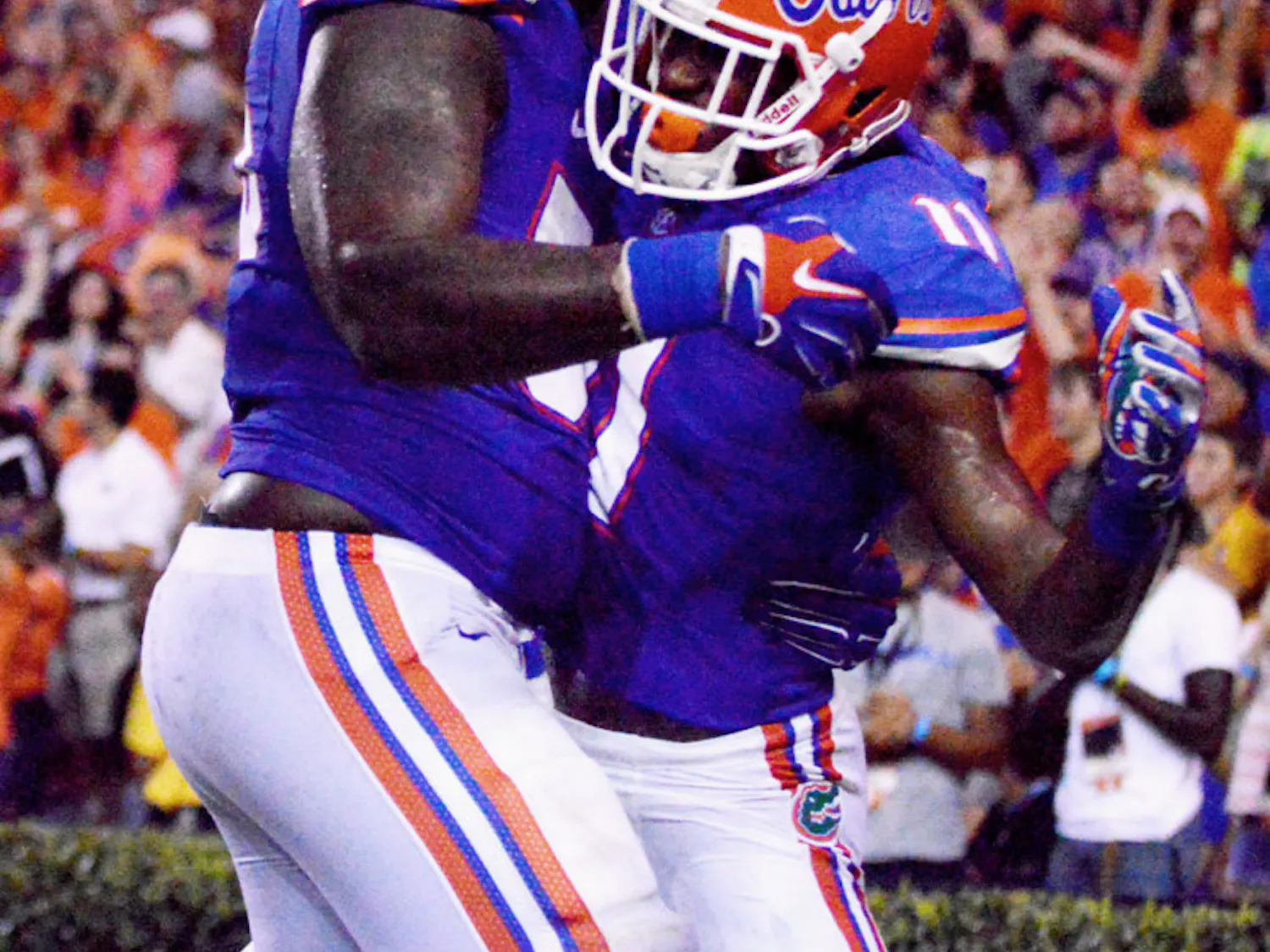 Teammates celebrate a touchdown with sophomore wide receiver Demarcus Robinson (11) during Florida's 36-30 overtime victory against Kentucky on Saturday at Ben Hill Griffin Stadium.