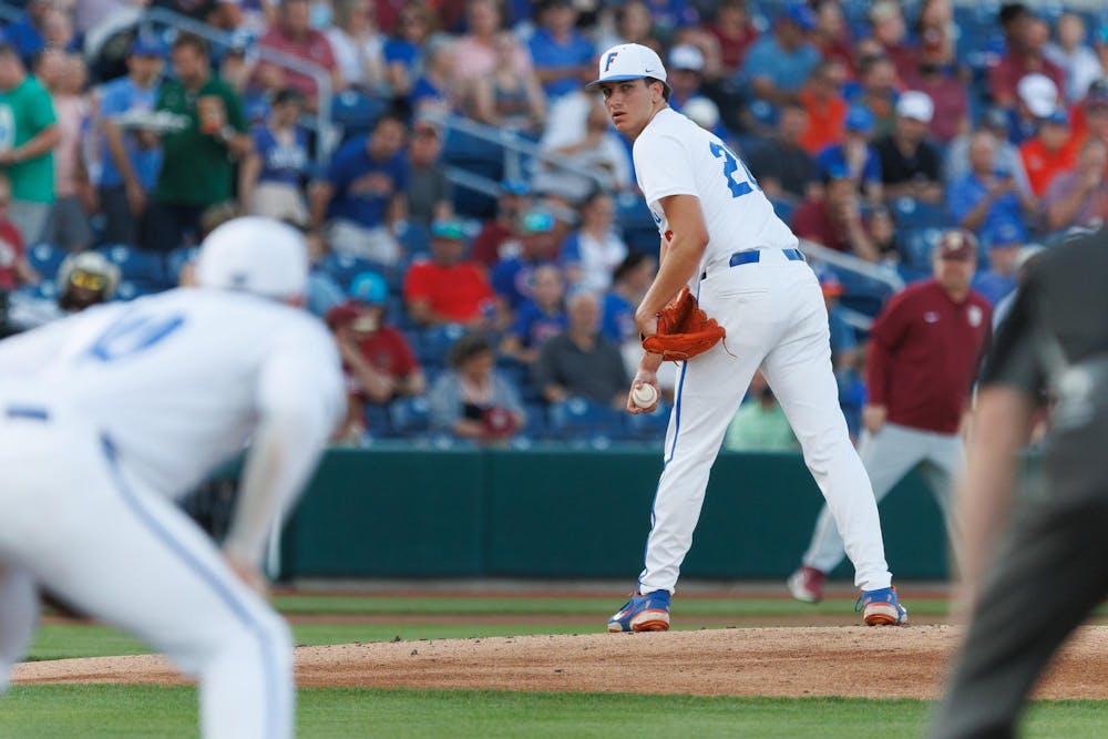 Florida right-handed pitcher Schuyler Sandford (20) watches the first base runner during an NCAA baseball game against Florida State University, Tuesday, March 10, 2026, in Gainesville, Fla.