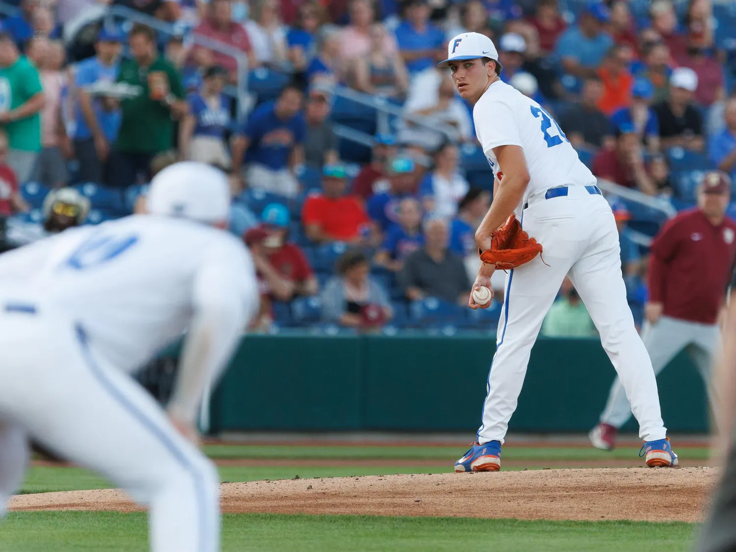 Florida right-handed pitcher Schuyler Sandford (20) watches the first base runner during an NCAA baseball game against Florida State University, Tuesday, March 10, 2026, in Gainesville, Fla.