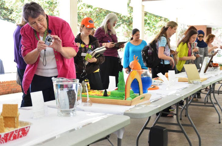George A. Smathers Library staff member Jane Anne Carey takes a photo of an edible book on the Library West walkway during the Edible Book Contest on Thursday.