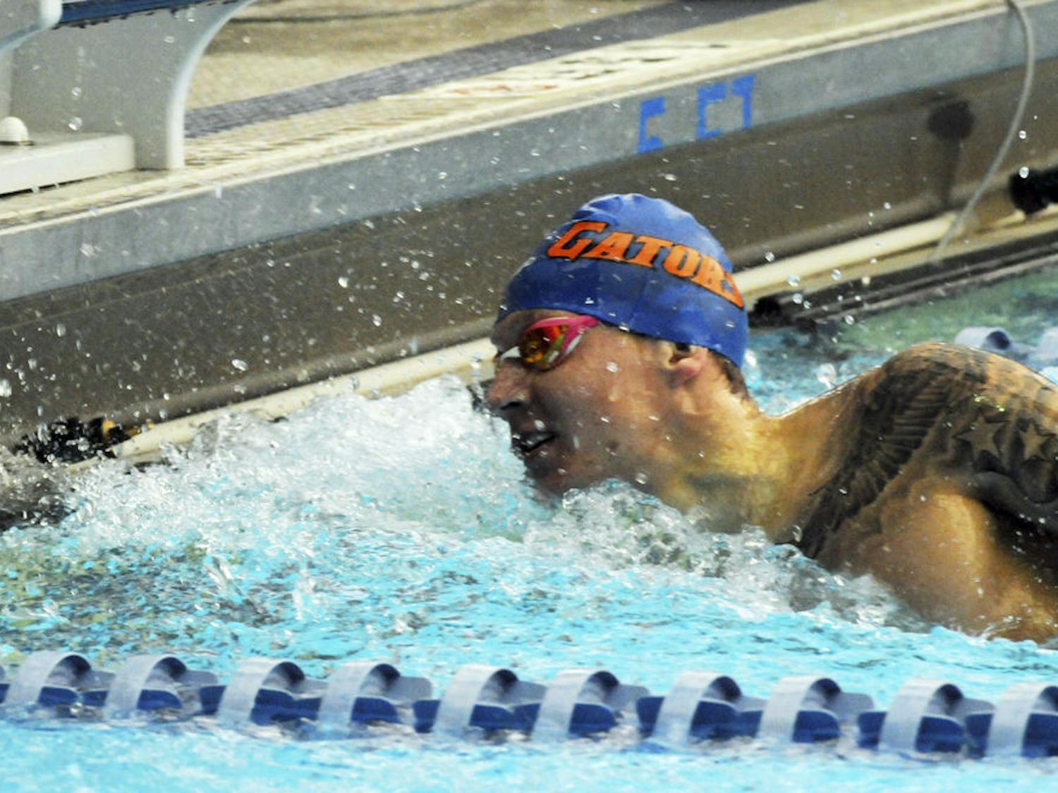 Caeleb Dressel touches the wall at the end of his leg of the 400 meter freestyle relay during Florida’s meet against Auburn on Jan. 23, 2016, in the O’Connell Center.