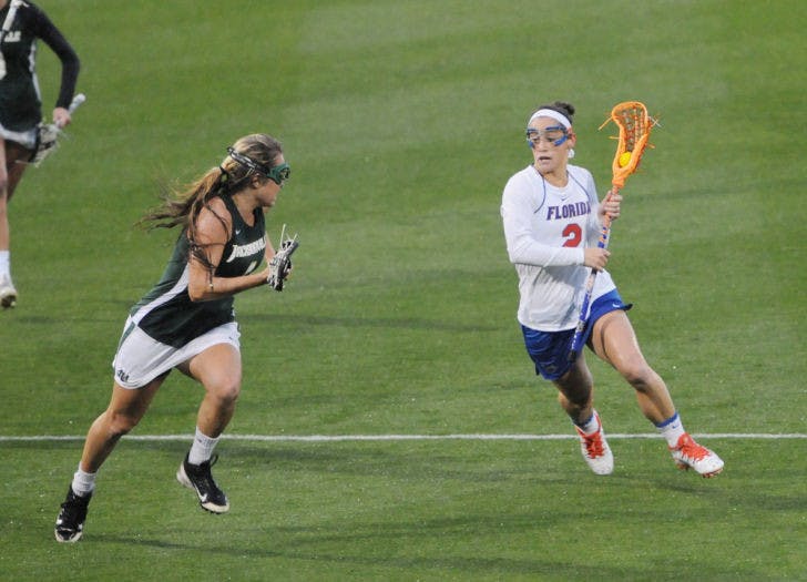 Sammi Burgess (2) drives toward the net during Florida’s 21-5 win against Jacksonville on Feb. 12 at Donald R. Dizney Stadium. Burgess scored four goals against Vanderbilt on Sunday.