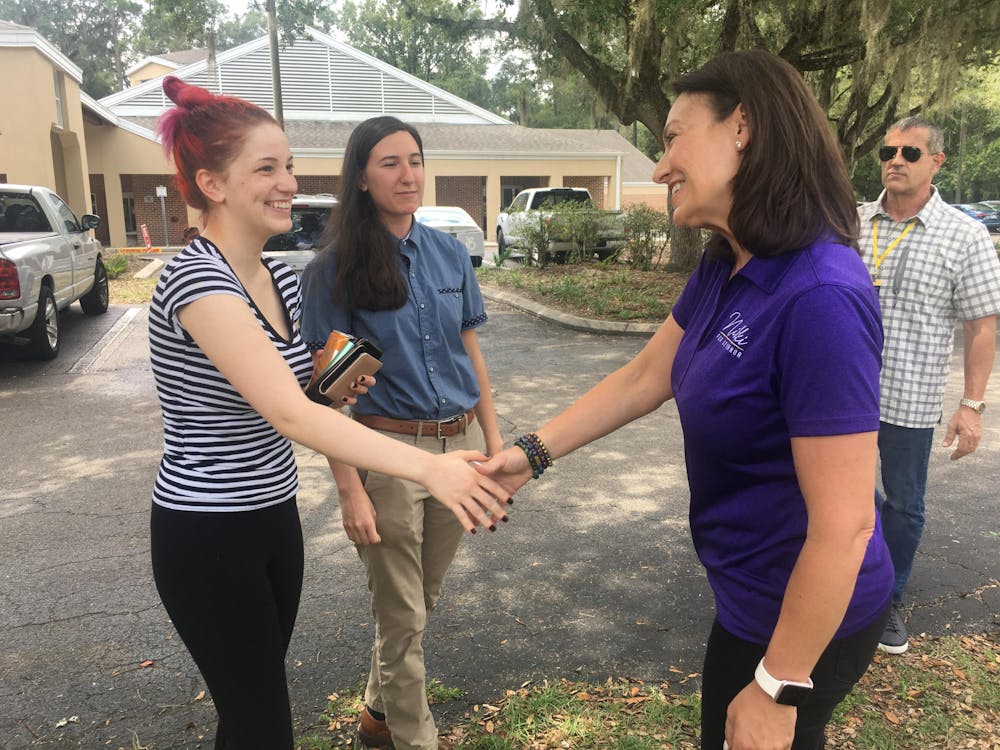 <p>Nikki Fried, a Democratic candidate for governor, greets Emily Blais, a 23-year-old UF microbiology and English alumna, at the Get Out The Vote bus tour stop at the Tower Road Branch Library Thursday, August 18, 2022.</p>