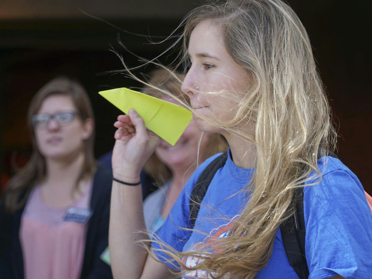 Mariana Franz, a 20-year-old UF applied physiology and kinesiology junior, tosses her paper airplane outside Ben Hill Griffin Stadium on Oct. 20, 2015. The College of Journalism and Communications and the College of Health and Human Performance held a paper airplane competition to raise money for the UF Campaign for Charities.