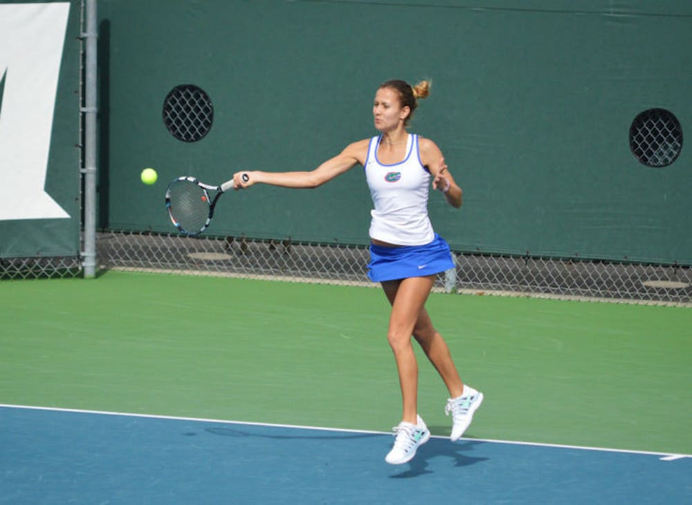 <p>Olivia Janowicz hits the ball during Florida’s 4-0 win against Harvard on Sunday at the Ring Tennis Complex. Janowicz won her first match on the No. 1 court on Wednesday, defeating UCF’s Josephine Haraldson in straight sets.</p>