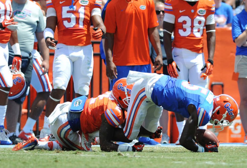 <p>Ahmad Fulwood (5) recovers from a tackle made by Jabari Gorman (2) during Florida’s Orange and Blue Debut on Saturday in Ben Hill Griffin Stadium. Fulwood is one of several sophomore wide receivers who expect to have a large role in the Gators’ offense in 2014.</p>