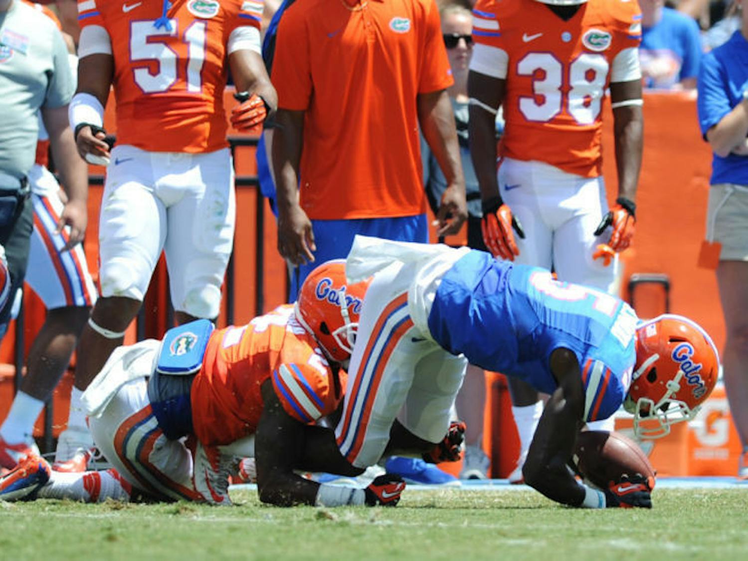 Ahmad Fulwood (5) recovers from a tackle made by Jabari Gorman (2) during Florida’s Orange and Blue Debut on Saturday in Ben Hill Griffin Stadium. Fulwood is one of several sophomore wide receivers who expect to have a large role in the Gators’ offense in 2014.