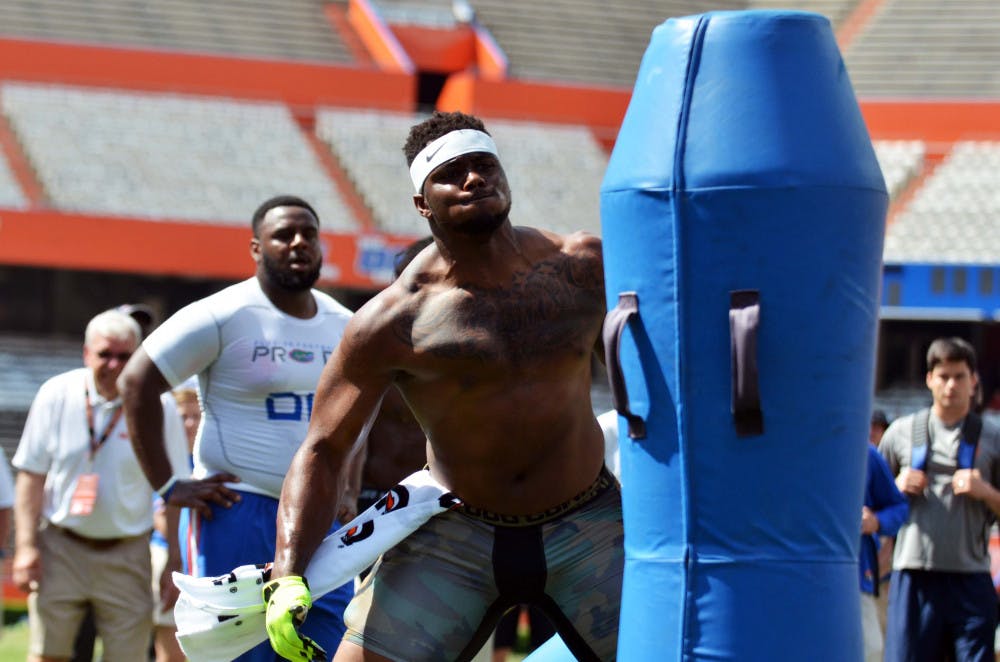 <p>Dante Fowler participates in a drill during Florida's Pro Day on Tuesday at Ben Hill Griffin Stadium.</p>