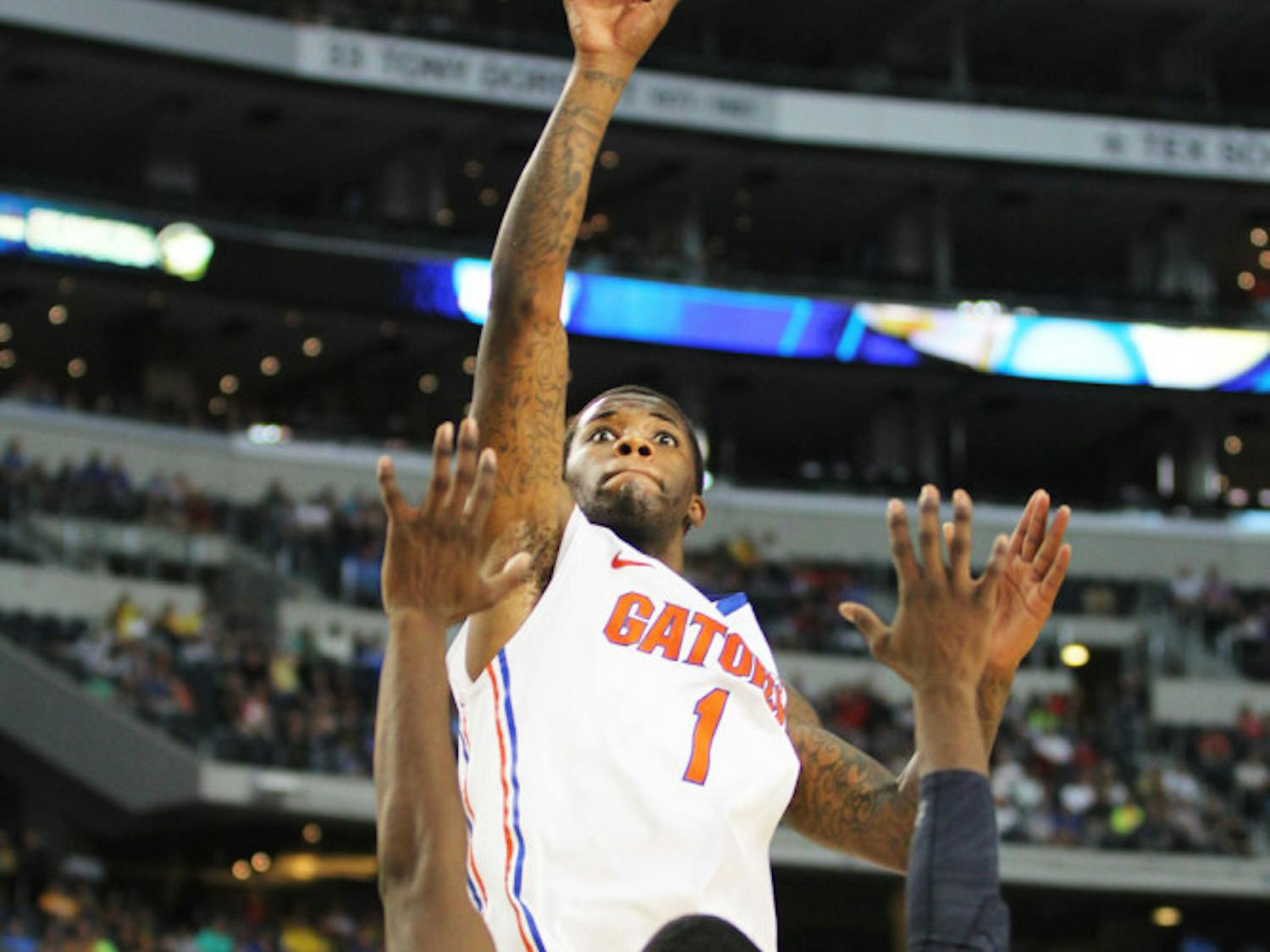 Senior guard Kenny Boynton attempts a shot against Michigan guard Tim Hardaway Jr. during Florida’s 79-59 loss on Sunday in Cowboys Stadium. Boynton missed the cut for the Los Angeles Lakers' summer league roster, which was released Thursday.