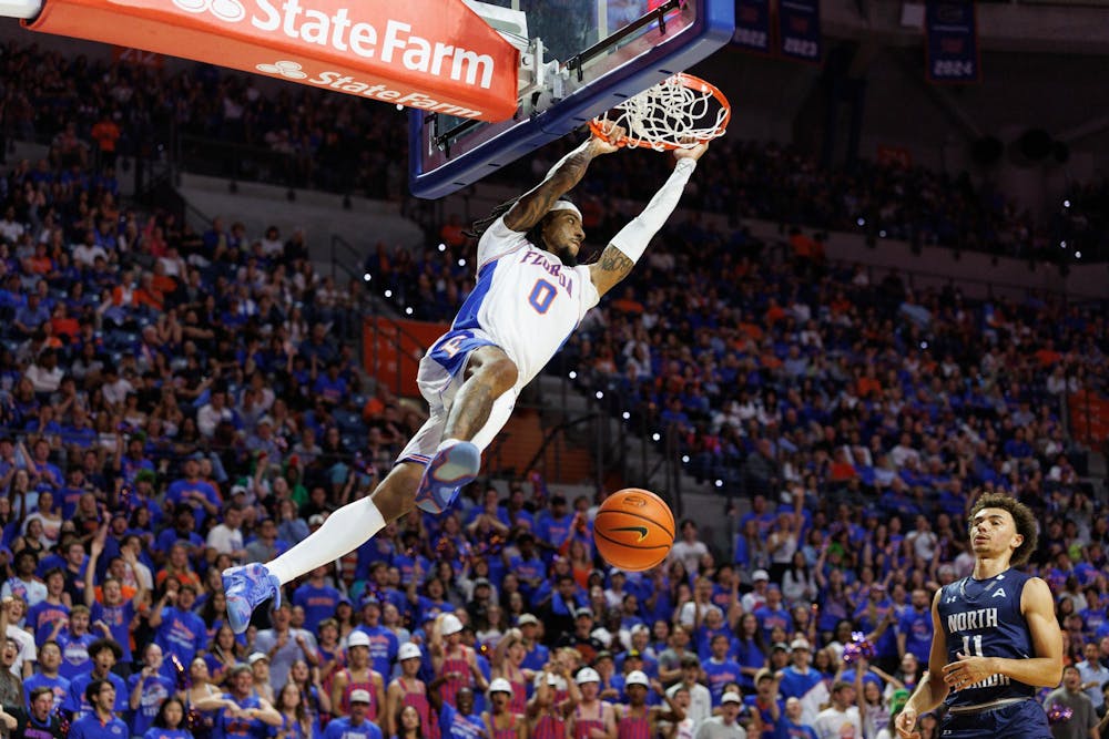 Florida Gators guard Boogie Fland (0) dunks during the first half of a NCAA college basketball game against North Florida, Thursday, Nov. 06, 2025, in Gainesville, Fla.