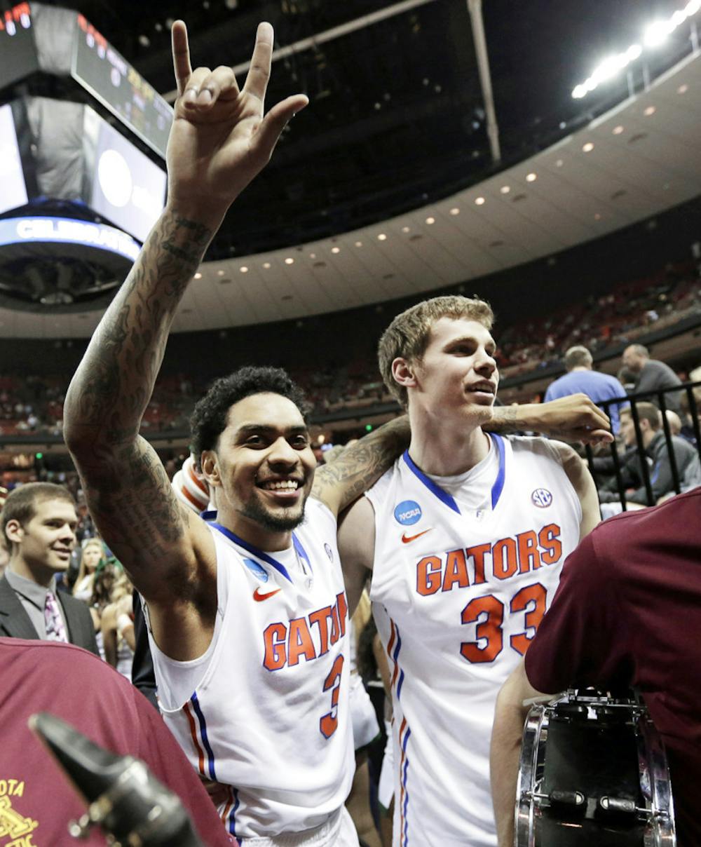 <p class="p1"><span class="s1">Redshirt senior guard Mike Rosario (3) celebrates with senior forward Erik Murphy (33) after Florida’s 78-64 victory against Minnesota on Sunday in Austin, Texas.</span></p>