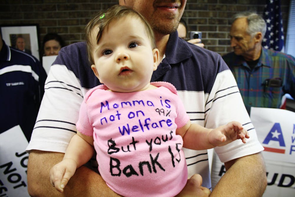 <p>Seven-month-old Lumen sits in the arms of her father, Brian Klepp, during a MoveOn.org protest in U.S. Rep. Cliff Stearns' office Thursday. MoveOn.org members were supporting Occupy Wall Street.</p>