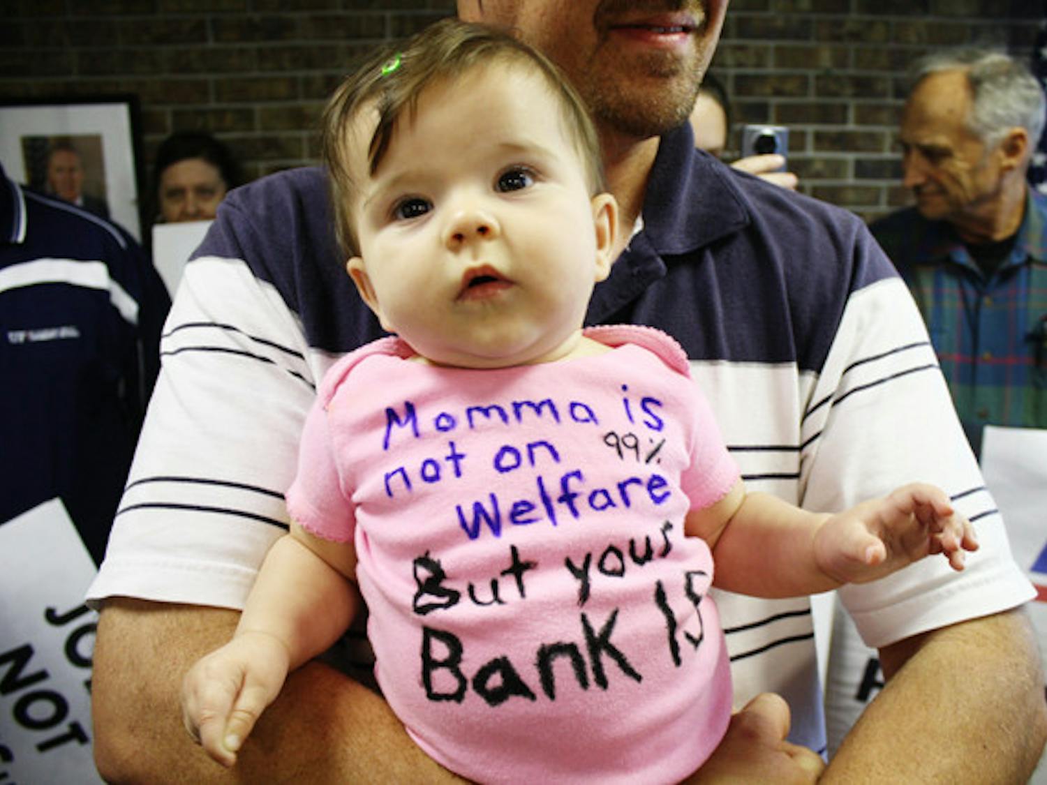 Seven-month-old Lumen sits in the arms of her father, Brian Klepp, during a MoveOn.org protest in U.S. Rep. Cliff Stearns' office Thursday. MoveOn.org members were supporting Occupy Wall Street.
