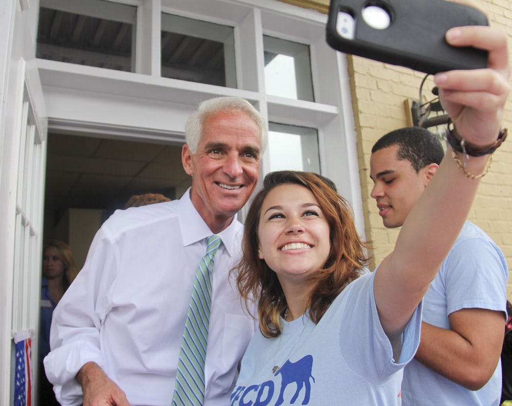 Stefani Dopico, a 19-year-old UF telecommunication sophomore, takes a selfie with Charlie Crist at the Alachua County Office of the State Attorney Sunday afternoon.&nbsp;