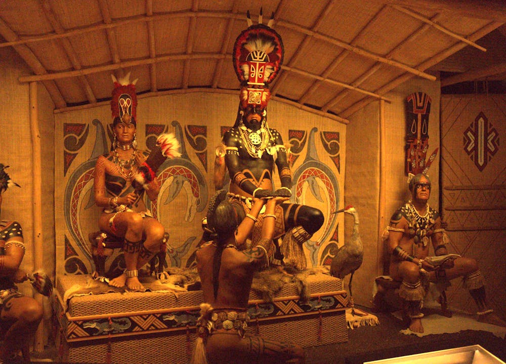 Statues of the Calusa Indians sit inside a hut as part of the “South Florida Peoples and Their Environment” exhibit at the Florida Museum of Natural History on Thursday, Oct. 19, 2023.

