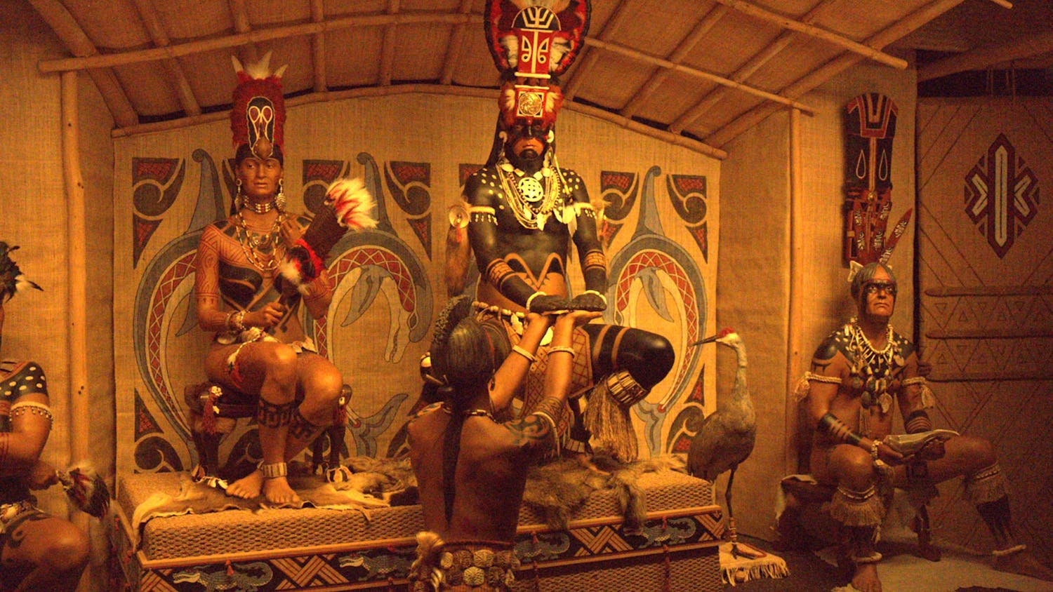 Statues of the Calusa Indians sit inside a hut as part of the “South Florida Peoples and Their Environment” exhibit at the Florida Museum of Natural History on Thursday, Oct. 19, 2023.
