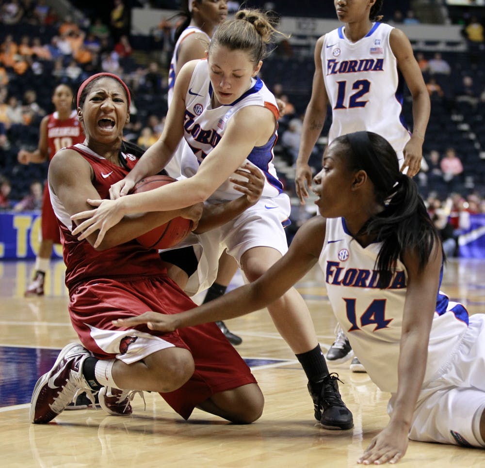 Arkansas guard Lyndsay Harris fights for a rebound with Florida guard Jordan Jones and forward Ndidi Madu during UF’s 68-59 win in Nashville, Tenn., on Thursday.