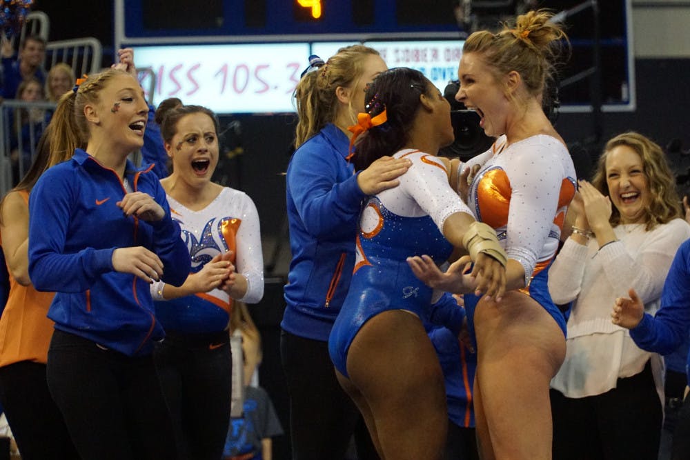 UF gymnast Bridget Sloan (right) celebrates with teammate Kennedy Baker after Baker scored a perfect 10.0 on her floor exercise routine during Florida's win against Alabama on Jan. 29, 2016, in the O'Connell Center.