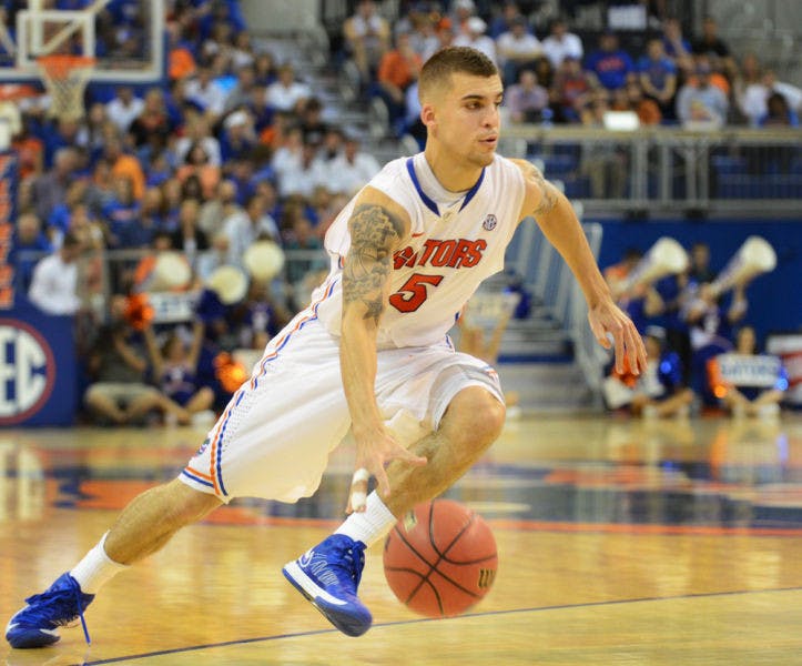 Point guard Scottie Wilbekin dribbles to the lane during Florida’s 77-44 win against Georgia on Jan. 9 in the O’Connell Center. UF suspended Wilbekin indefinitely on Monday for violating team rules.&nbsp;
