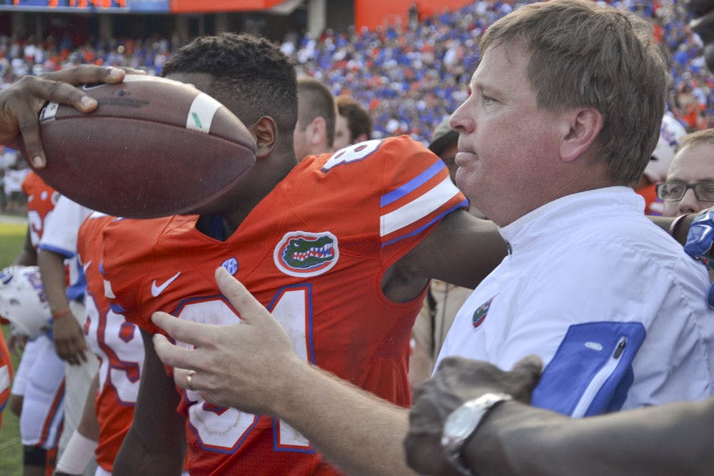 <p>UF football coach Jim McElwain receives the game ball following Florida's 9-7 win against Vanderbilt on Nov. 7, 2015, at Ben Hill Griffin Stadium.</p>
