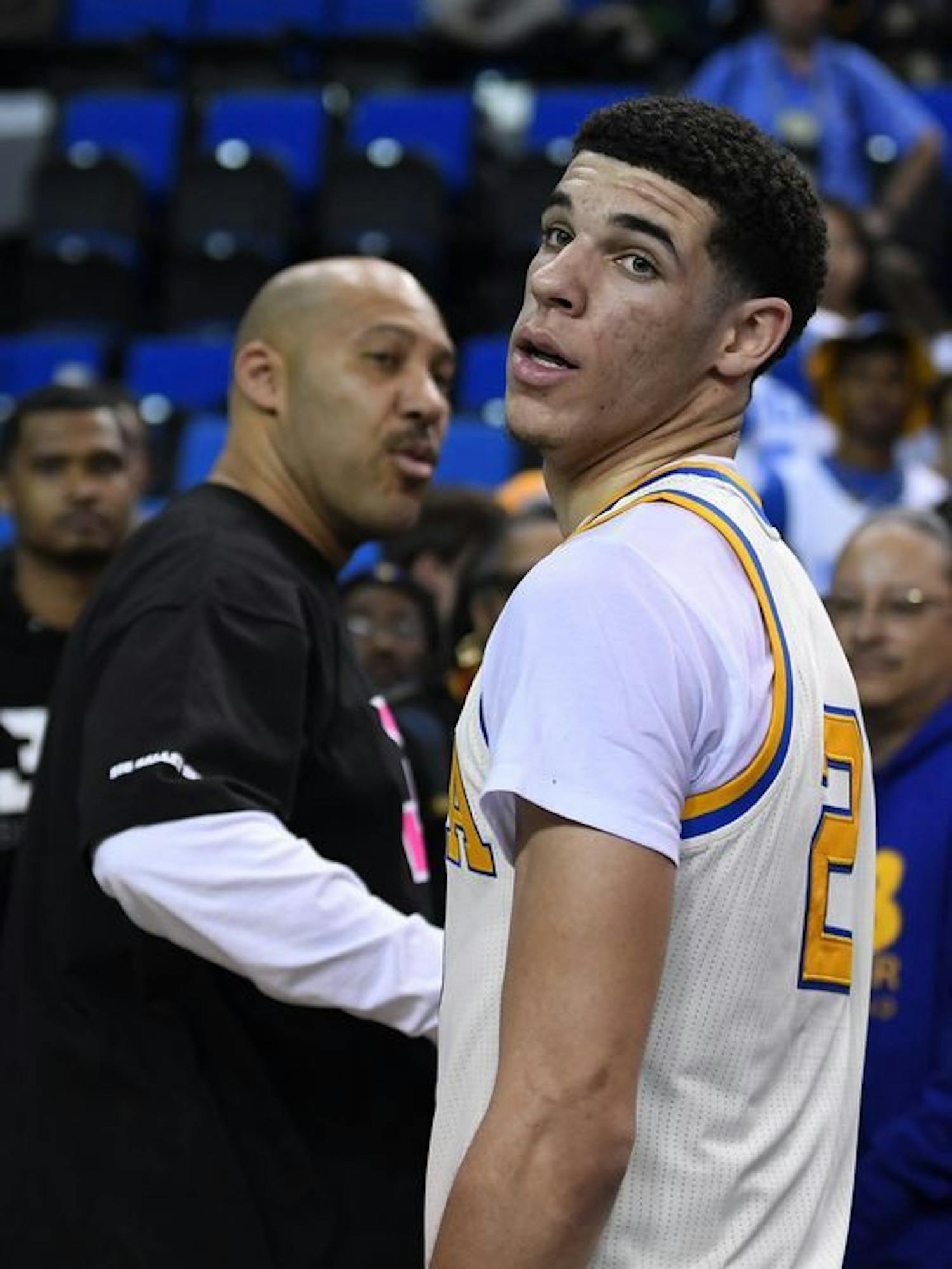 Former UCLA point guard Lonzo Ball (right) and his father, LaVar, shake hands after a game during the 2016-17 college basketball season.