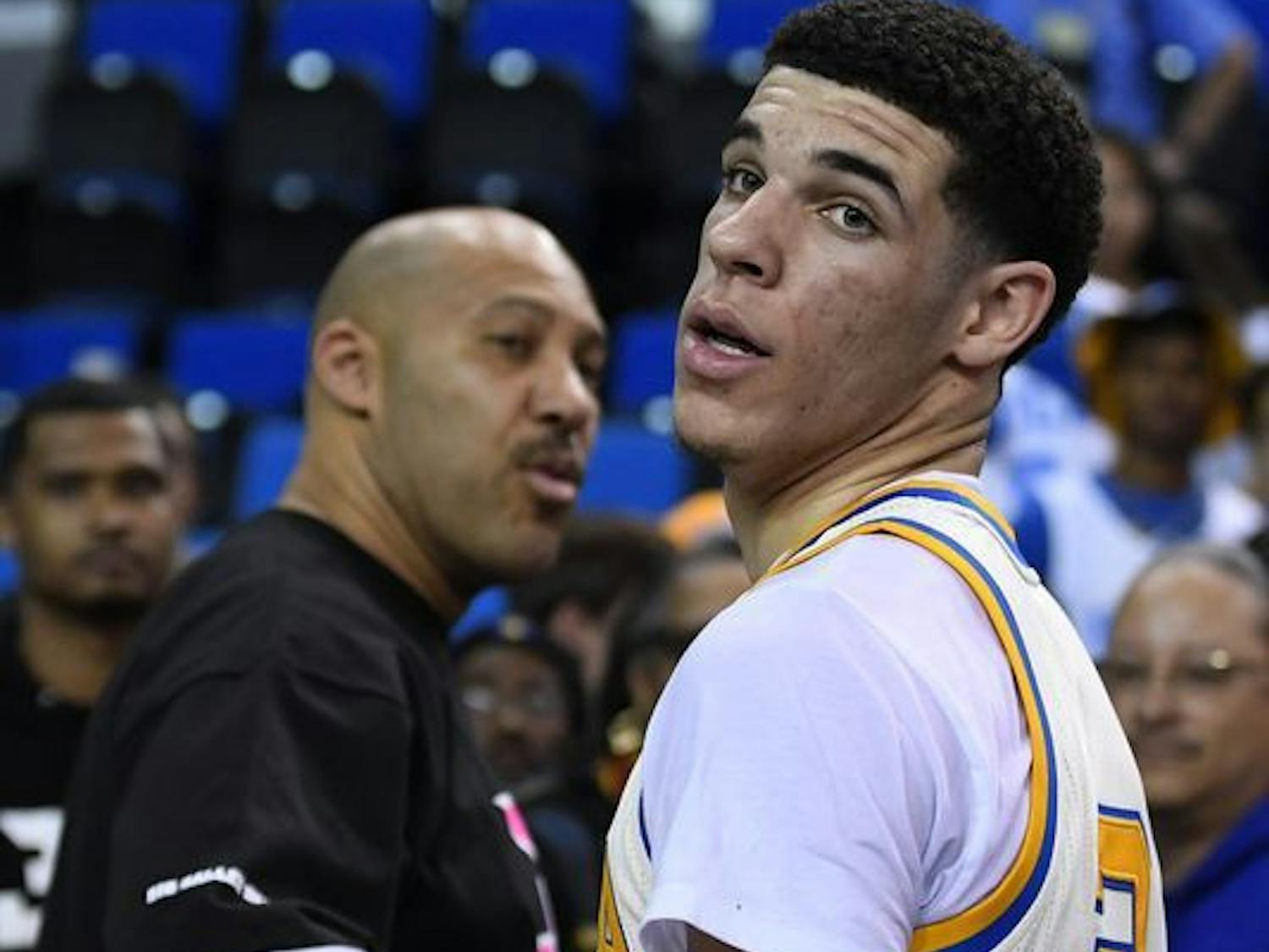 Former UCLA point guard Lonzo Ball (right) and his father, LaVar, shake hands after a game during the 2016-17 college basketball season.