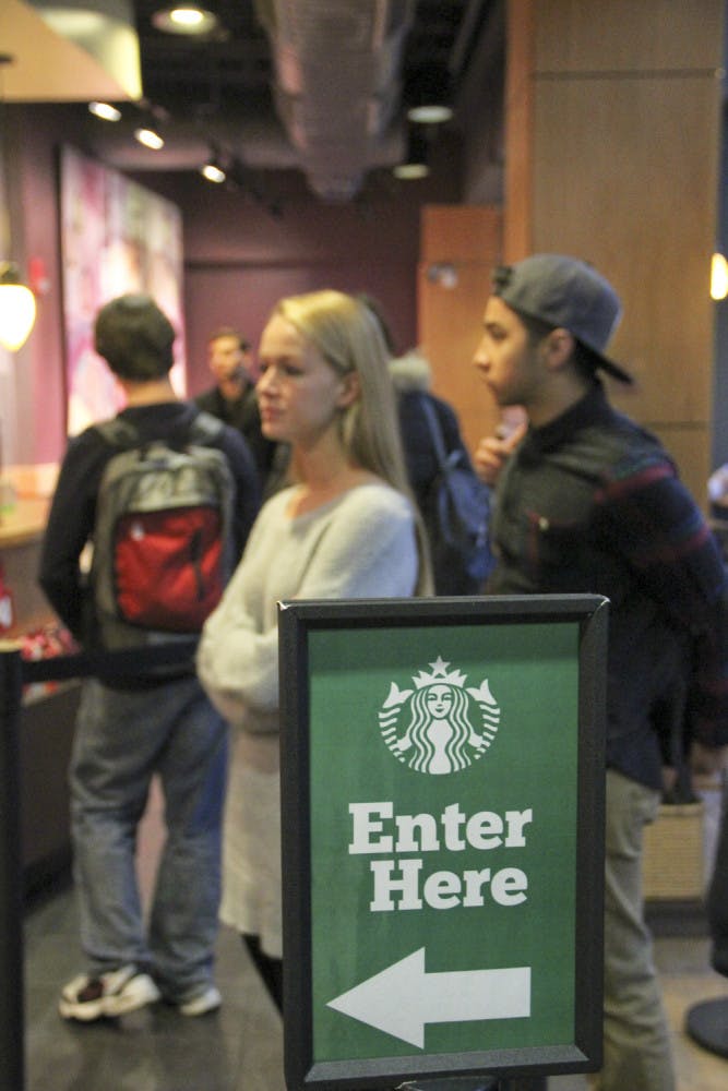Hanna Smith (left), a 20-year-old UF philosophy sophomore, stands in the line at the Starbucks in Library West on Monday afternoon. Smith said she was studying for her agricultural ecology final. “I was falling asleep up there, so I thought it was time for a Starbucks run.”
