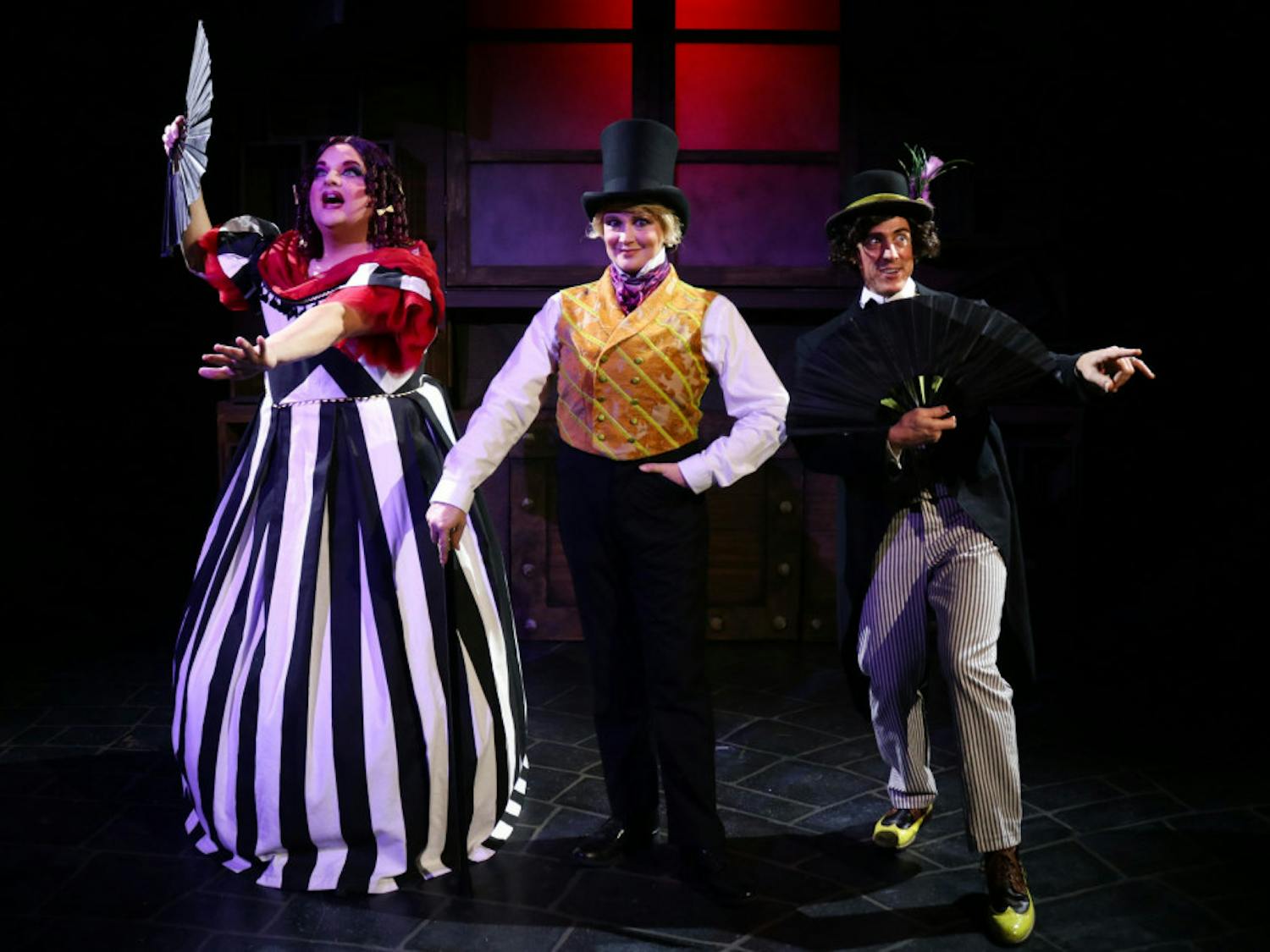 Actors Matthew McGee, Kelly Atkins and David Patrick Ford take center stage in costume for their roles in the Hippodrome's "Scrooge in Rouge."