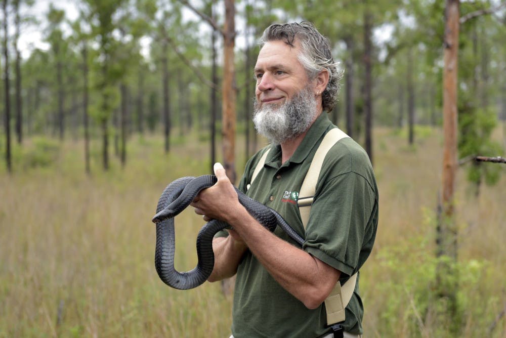 David Printiss holds an eastern indigo at the release.