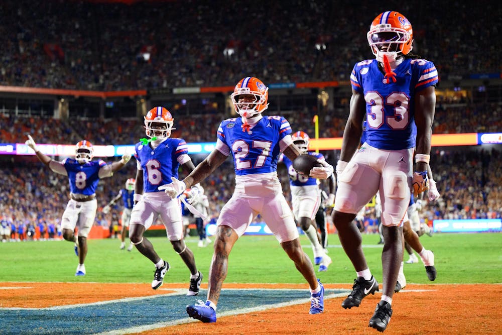 Florida cornerback Dijon Johnson (27), cornerback J'Vari Flowers (6) and safety DJ Coleman (33) celebrate a fumble recovery during the first half of an NCAA college football game against FAU, Saturday, Sept. 5, 2026, in Gainesville, Fla.